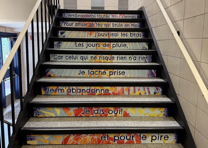 **Escalier décoré d’une mosaïque artistique et de paroles inspirantes réalisées par les élèves.